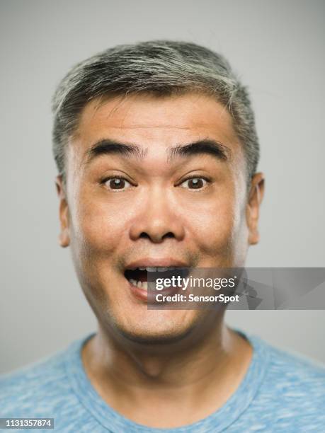 porträt eines echten chinesischen reifen mannes mit überraschtem ausdruck mit blick auf die kamera - surprised face stock-fotos und bilder