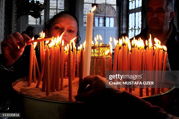 Greek Orthodox people light candles during an Easter rite at St. George's Church in Fener Patriarchate, Istanbul, on April 24, 2011. AFP...