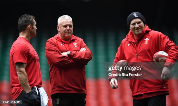 Wales coach Warren Gatland chats with coaches Huw Bennett and Neil Jenkins during Wales training ahead of the Six Nations match against England at...