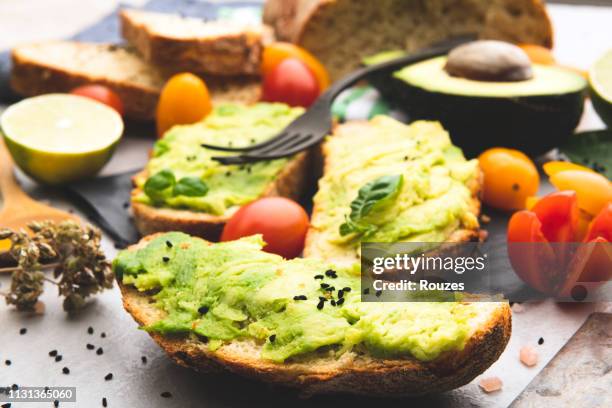 avocado toast with whole grain rye bread. - nigella stock pictures, royalty-free photos & images