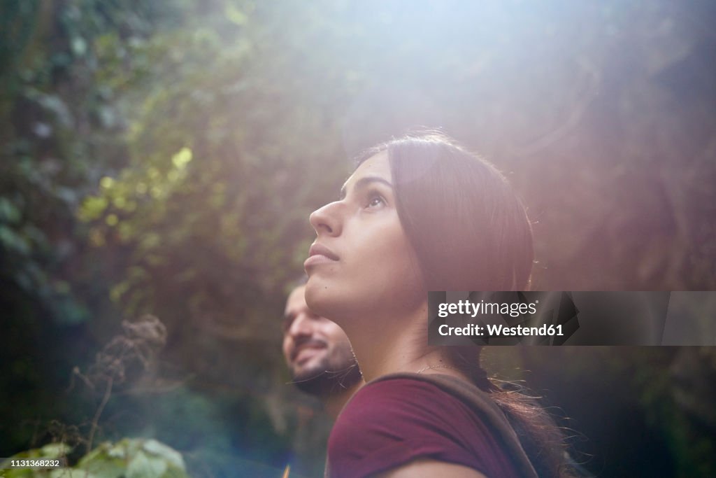 Spain, Canary Islands, La Palma, female hiker with boyfriend in a forest looking up