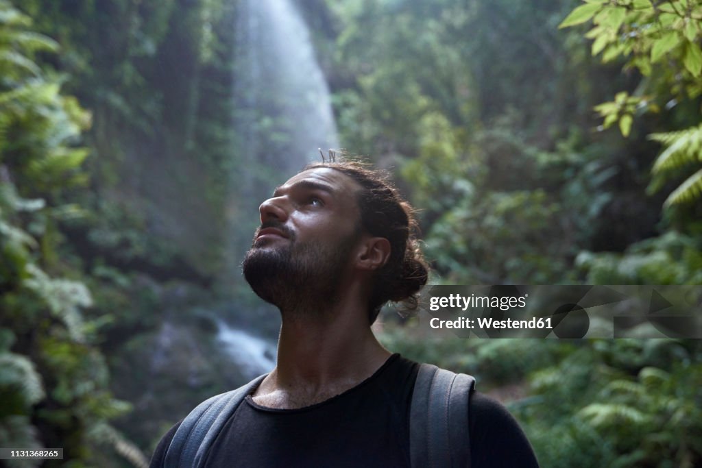 Spain, Canary Islands, La Palma, close-up of bearded man near a waterfall in the forest