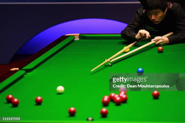 Ding Junhui of China plays a shot in the round two game against Stuart Bingham on day nine of the Betfred.com World Snooker Championship at The...