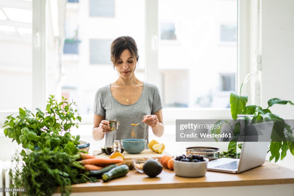Woman preparing healthy food in her kitchen