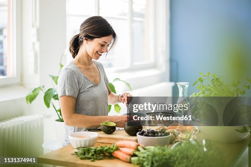 Woman preparing healthy food in her kitchen Woman preparing healthy food in her kitchen