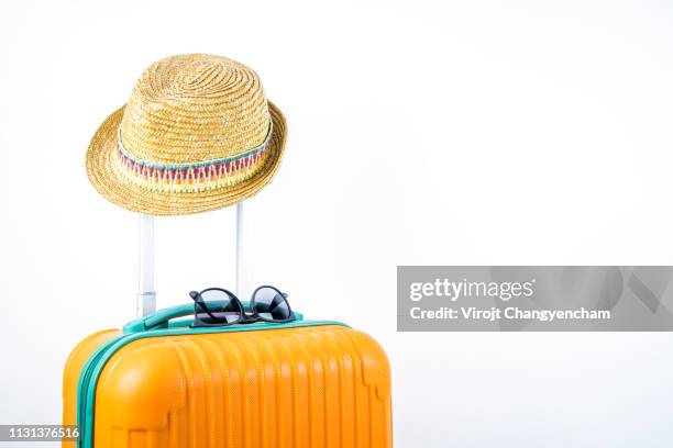 summertime concept, travel bag and straw hat on white isolated background - carry on luggage photos et images de collection