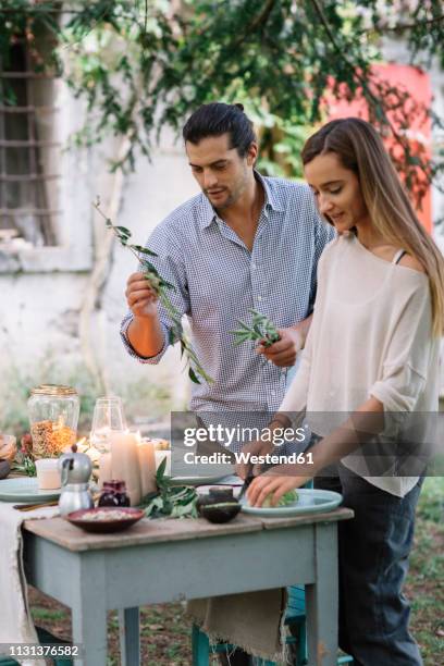 couple preparing a romantic candelight meal outdoors - food rustic stock pictures, royalty-free photos & images