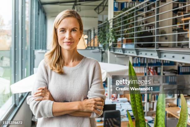 portrait of confident woman in office - casual man portrait stock-fotos und bilder