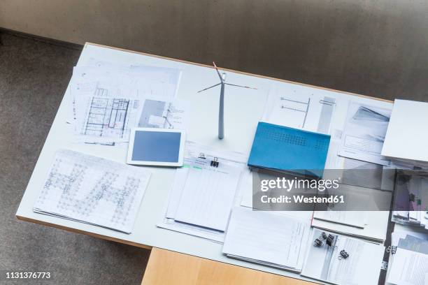 wind turbine model, construction plans and tablet on table in office - 2018 blueprint stock-fotos und bilder