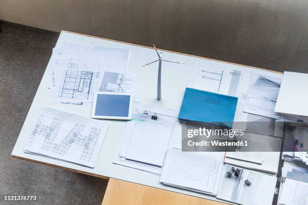 wind turbine model, construction plans and tablet on table in office - 2018 blueprint stock pictures, royalty-free photos & images