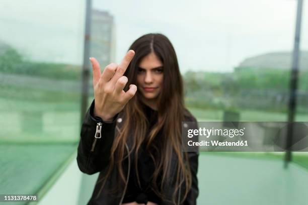 young woman giving the finger - ののしりのジェスチャー ストックフォトと画像