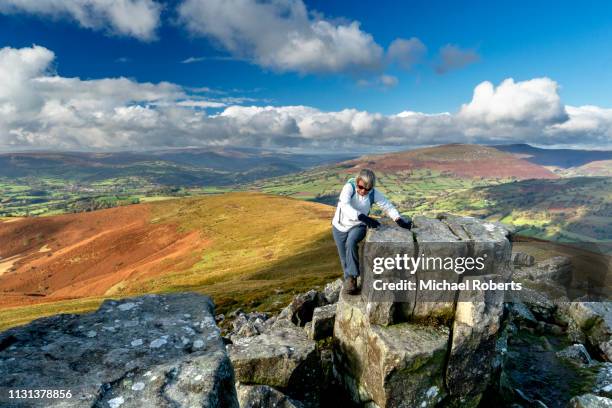 woman hiker climbing sugar loaf mountain (mynydd pen y fal) in the black mountains, brecon beacons national park - sugar loaf bildbanksfoton och bilder