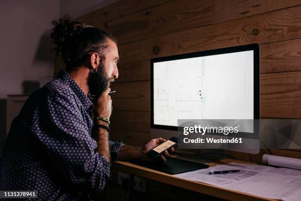 young architect working hard on a new project at home at night - staring at screen stock pictures, royalty-free photos & images