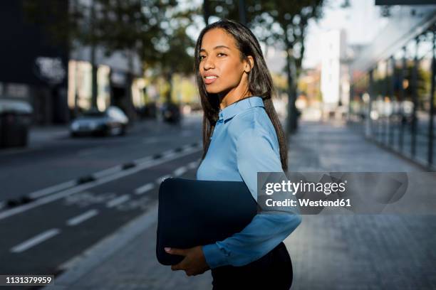 businesswoman with laptop bag in the city - laptop bag stock pictures, royalty-free photos & images