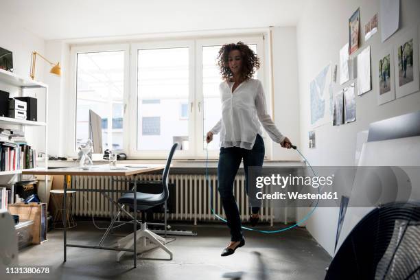 businesswoman in office, training with skipping rope - sports training bildbanksfoton och bilder