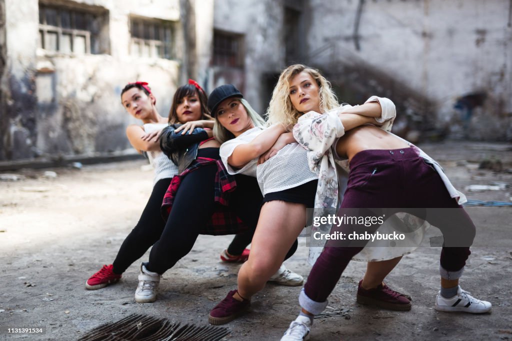 Group of female breakdancers are performing in old storage