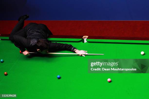 Ronnie O'Sullivan of England plays a shot in the round two game against Shaun Murphy of England on day nine of the Betfred.com World Snooker...