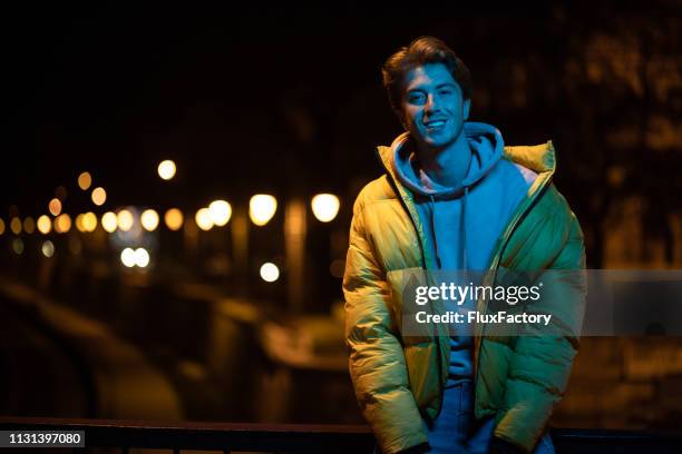 beautiful millennial smiling outdoors - winter coat stock pictures, royalty-free photos & images