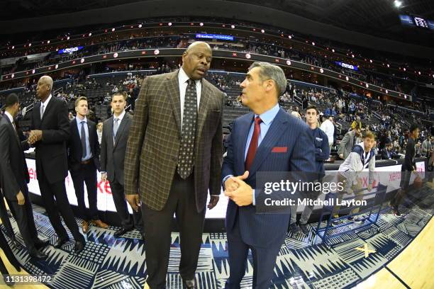 Head coach Jay Wright of the Villanova Wildcats talks with head coach Patrick Ewing Jr. Of the Georgetown Hoyas before a college basketball game at...