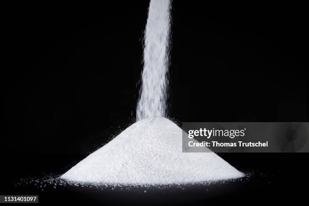 Berlin, Germany In this photo illustration Sugar is shaken out of a bag on a pile on March 14, 2019 in Berlin, Germany.