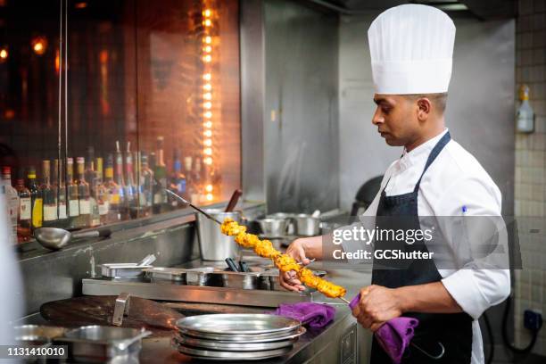 chef preparing chicken tikka - tandoor oven stock pictures, royalty-free photos & images