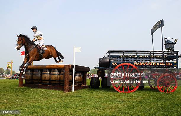 Harry Meade riding Wild Lone jumps over the Wadworth Barrels as they compete in the cross country stage during day three of the Badminton Horse...