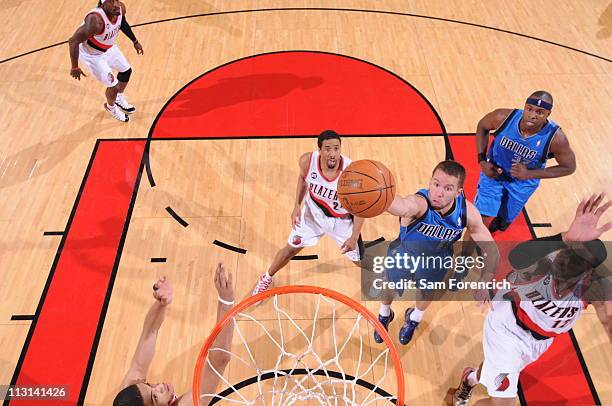 Jose Barea of the Dallas Mavericks shoots against LaMarcus Aldridge and Nicolas Batum of the Portland Trail Blazers in Game Four of the Western...