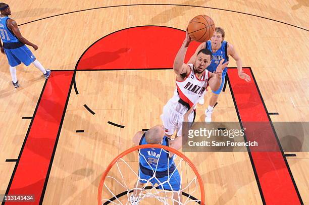 Brandon Roy of the Portland Trail Blazers shoots over Jason Kidd and Tyson Chandler of the Dallas Mavericks in Game Four of the Western Conference...