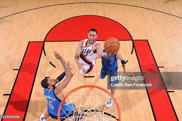 Brandon Roy of the Portland Trail Blazers shoots over Jason Kidd and Tyson Chandler of the Dallas Mavericks in Game Four of the Western Conference...
