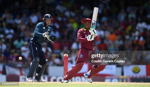 Shimron Hetmyer of the West Indies bats watched by England wicketkeeper Jos Buttler during the 2nd One Day International match between the West...