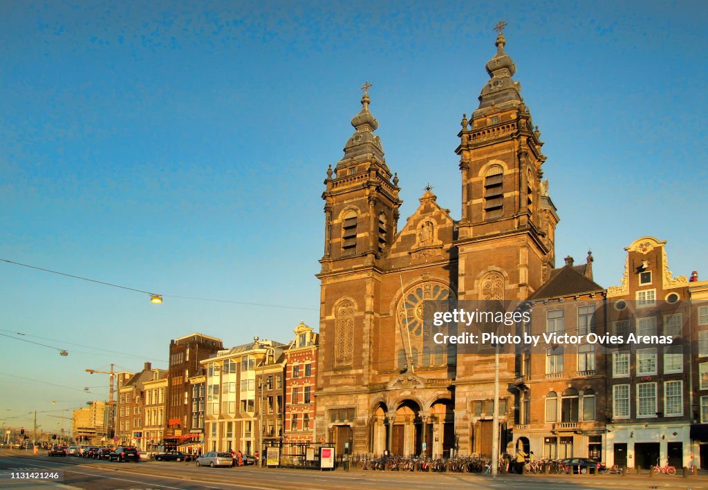 The church of Saint Nicholas on the Prins Hendrikkade quay near the Central Railway Station at sunset in Amsterdam, Netherlands