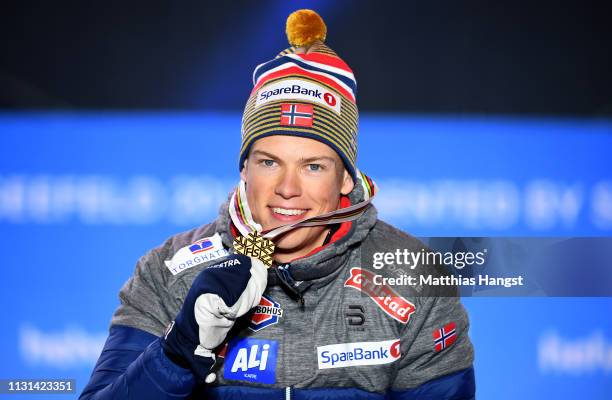 Gold medalist Johannes Hoesflot Klaebo of Norway celebrates during the medal ceremony for the Men's Cross Country Sprint at the Medal Plaza on...