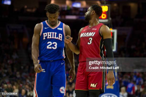 Jimmy Butler of the Philadelphia 76ers and Dwyane Wade of the Miami Heat walk down the court at the Wells Fargo Center on February 21, 2019 in...