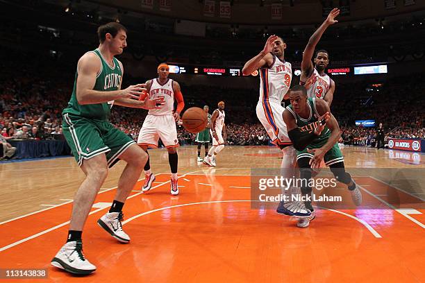 Rajon Rondo of the Boston Celtics passes the ball to Nenad Krstic against Jared Jeffries and Shawne Williams of the New York Knicks in Game Four of...