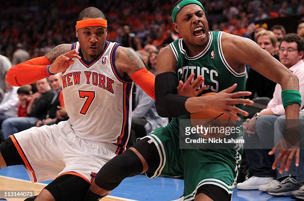 Carmelo Anthony of the New York Knicks and Paul Pierce of the Boston Celtics fight for control of a loose ball in the second half of Game Four of the...