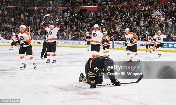 Paul Gaustad of the Buffalo Sabres reacts as the Philadelphia Flyers celebrate the game winning overtime goal scored by Ville Leino in Game Six of...