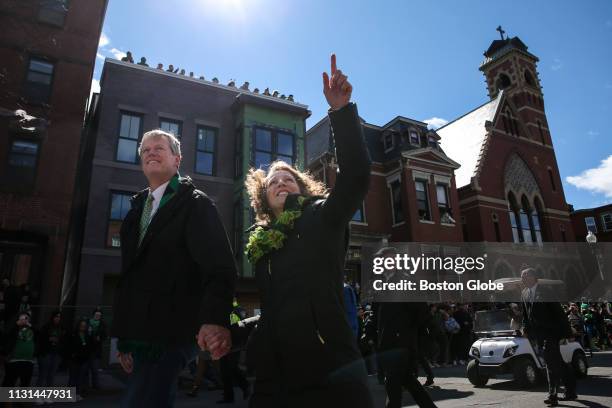 Massachusetts Governor Charlie Baker and his wife, Lauren Baker, walk in the annual St. Patrick's Day parade in South Boston on March 17, 2019.