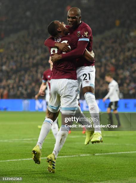 Issa Diop of West Ham United celebrates with teammate Angelo Ogbonna after scoring his team's second goal during the Premier League match between...