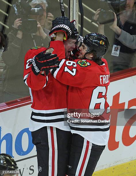 Michael Frolik of the Chicago Blackhawks hugs teammate Bryan Bickell after Bickells' 1st period goal against the Vancouver Canucks in Game Six of the...