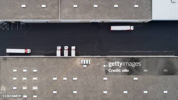 large industrial buildings roof and trucks - aerial view - overlooking factory stock pictures, royalty-free photos & images