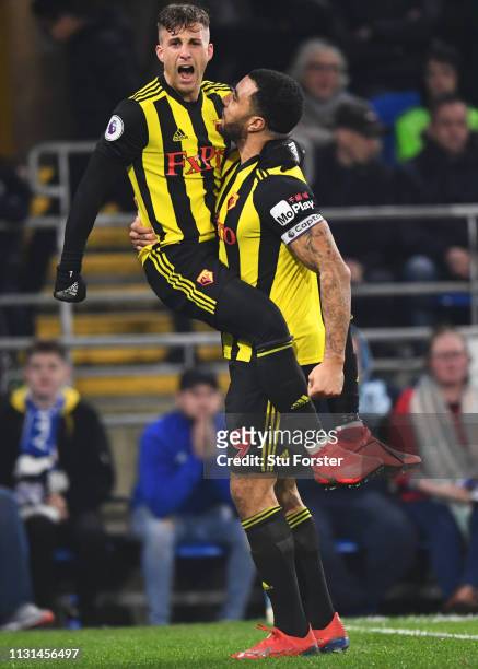 Gerard Deulofeu of Watford celebrates with Troy Deeney as he scores his team's second goal during the Premier League match between Cardiff City and...