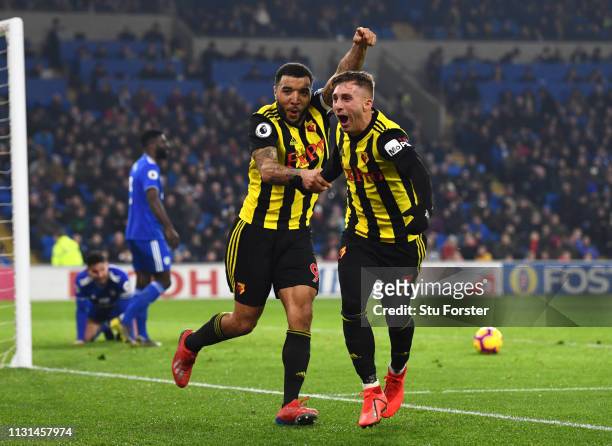 Troy Deeney of Watford celebrates with Gerard Deulofeu as he scores his team's fourth goal during the Premier League match between Cardiff City and...