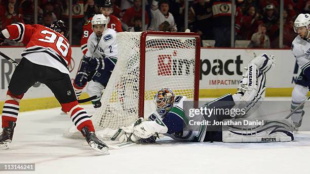 Cory Schneider of the Vancouver Canucks dives to make a save against Dave Bolland of the Chicago Blackhawks in Game Six of the Western Conference...