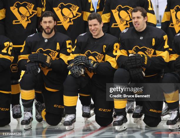 Kris Letang, Sidney Crosby and Evgeni Malkin of the Pittsburgh Penguins pose during a team photo prior to a practice session in advance of Saturday's...