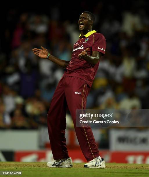 West Indies captain Jason Holder celebrates dismissing Tom Curran of England during the 2nd One Day International match between the West Indies and...