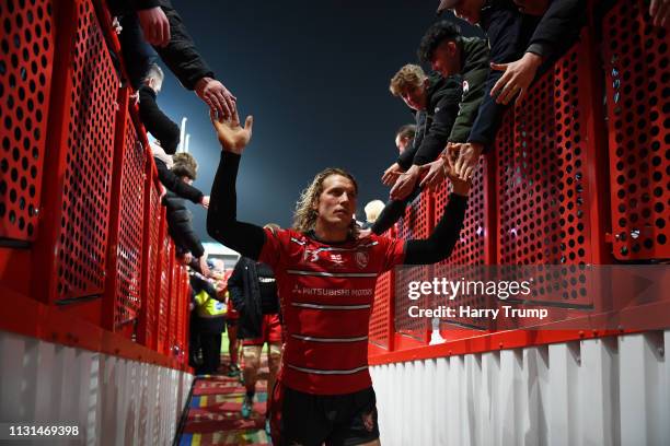 Billy Twelvetrees of Gloucester Rugby celebrates by high fiving the fans after the match during the Gallagher Premiership Rugby match between...