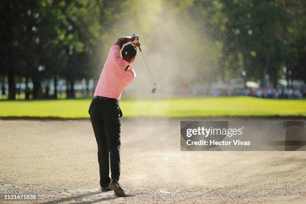 Tiger Woods of the United States plays his second shot on the ninth hole during the second round of World Golf Championships-Mexico Championship at...