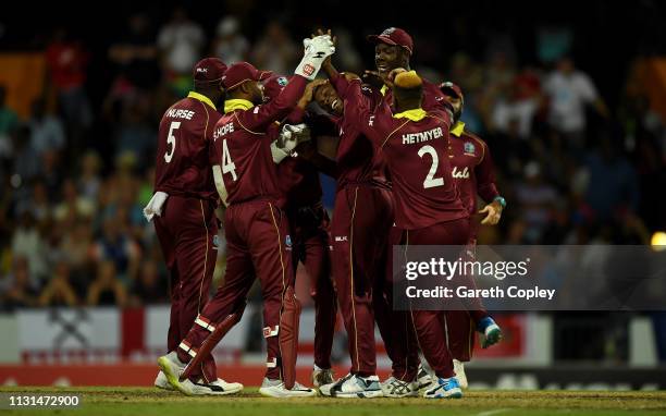 Sheldon Cottrell of the West Indies celebrates with teammates after dismissing Moeen Ali of England during the 2nd One Day International match...