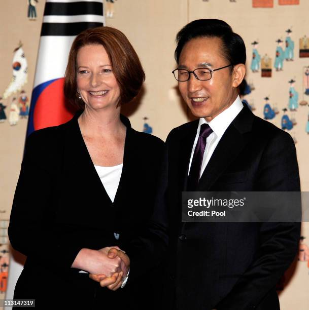 Australian Prime Minister Julia Gillard shakes hand with South Korean President Lee Myung-Bak before their meeting at the presidential house on April...