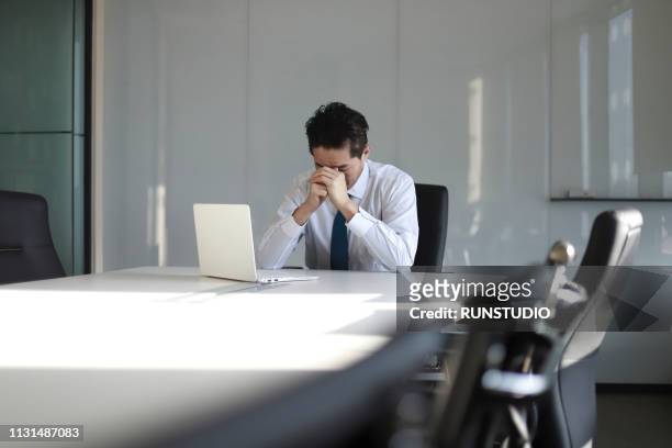 stressed mature businessman with laptop - worried stock-fotos und bilder